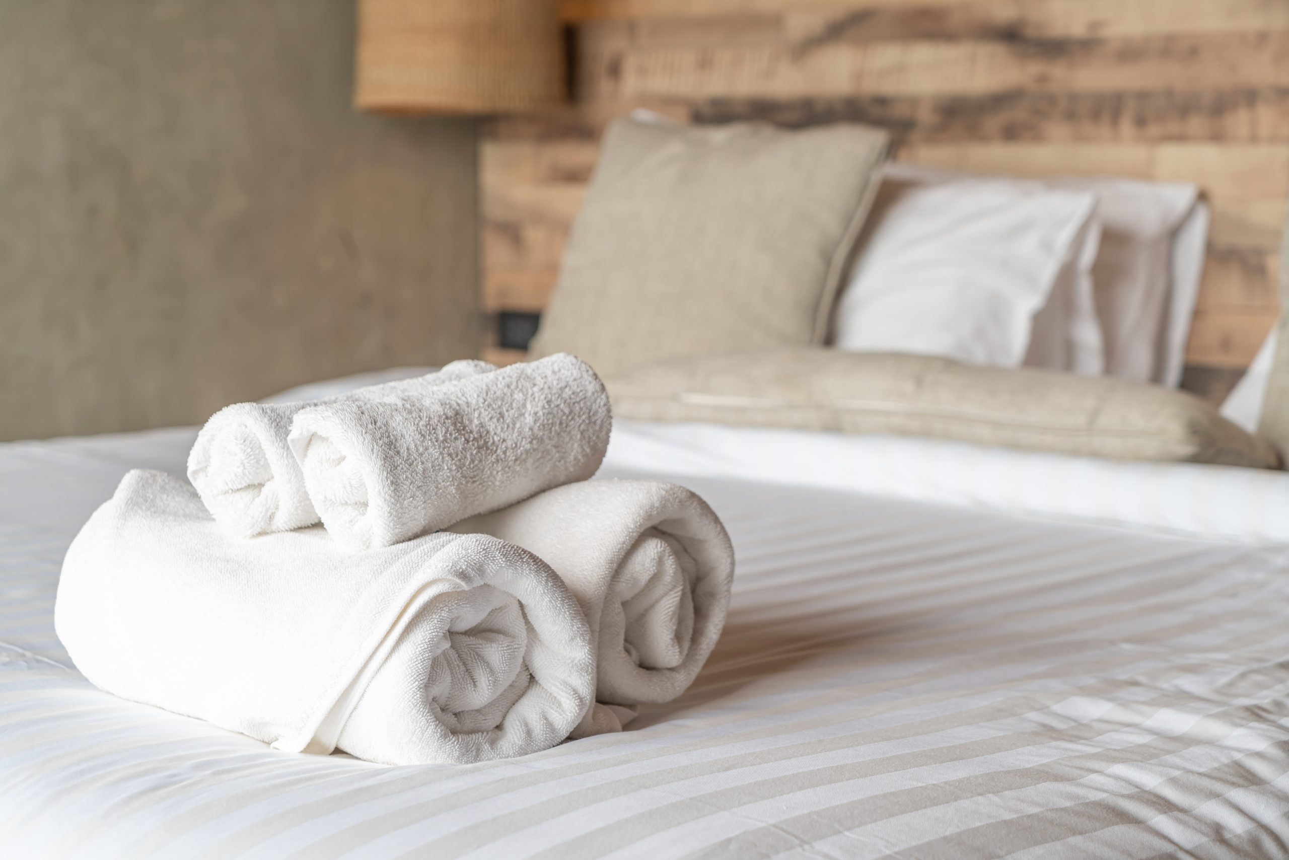 White towel on bed decoration in bedroom