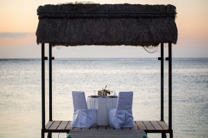 Romantic dinner setting on the beach at sunset
