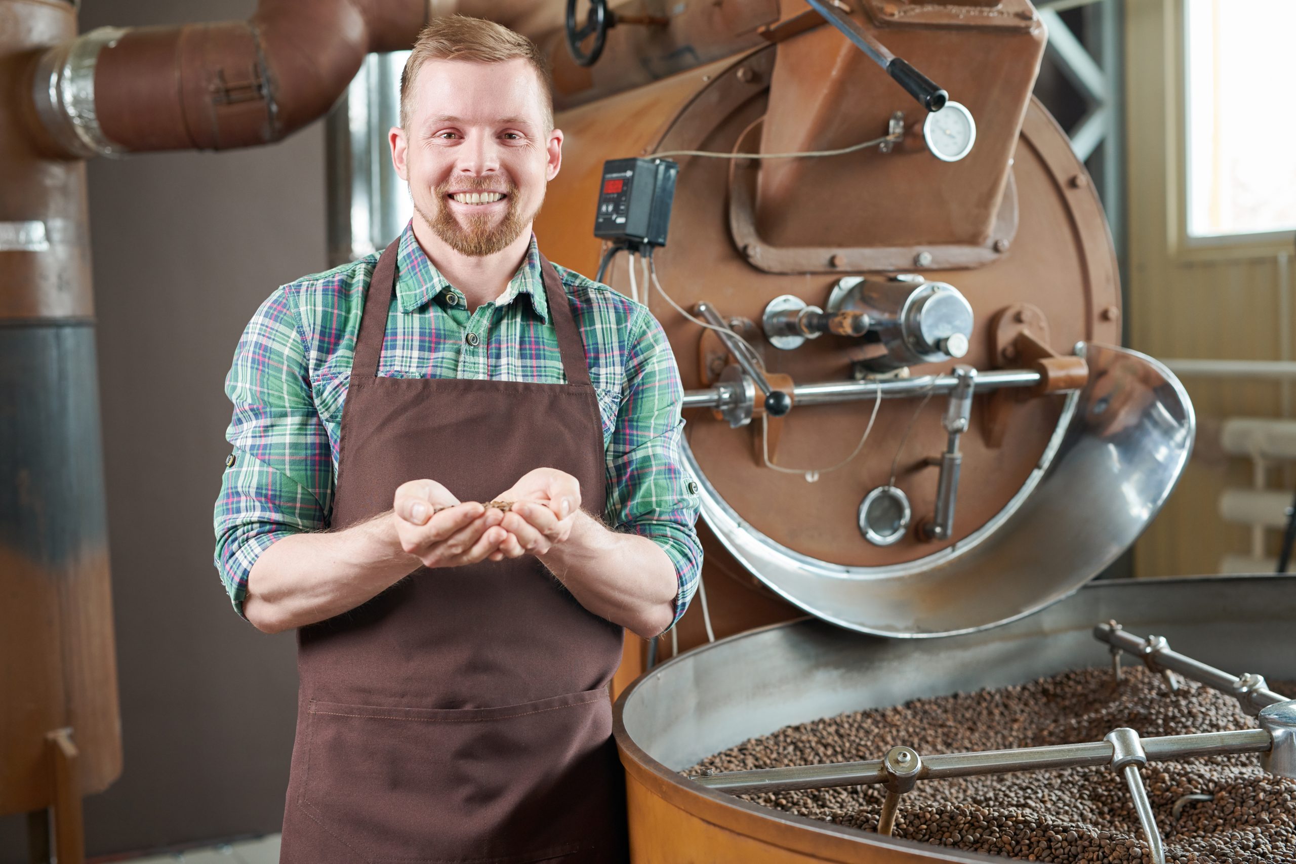 Coffee Roaster Posing by Machine