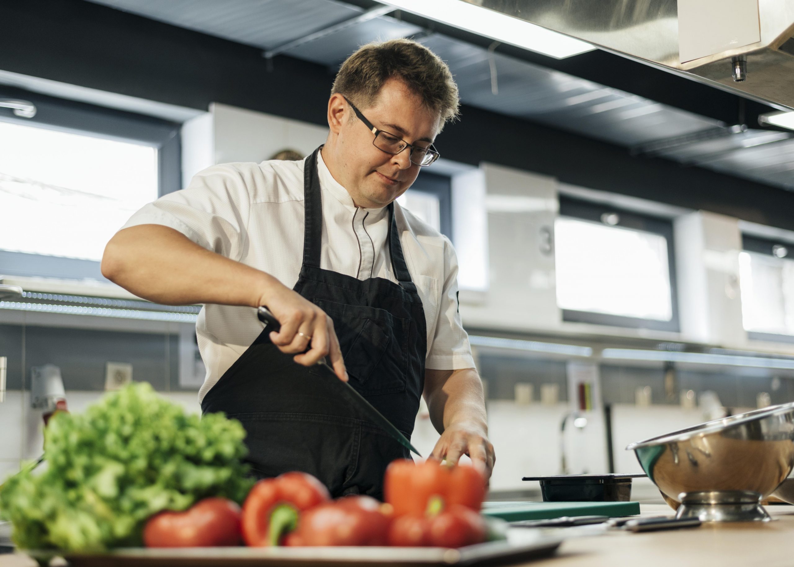 male-chef-chopping-tomatoes-kitchen